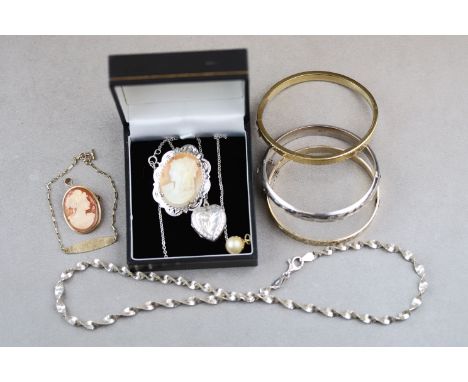 A 9ct yellow gold mounted cameo pendant brooch, a 9ct yellow gold dog tag bracelet, engraved Beatrice together with a silver 