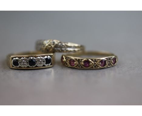 Three gem set 9ct yellow gold rings to include a ruby and diamond dress ring, a sapphire and diamond dress ring and diamond d