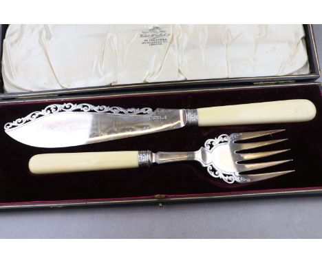 A cased set of Edwardian silver and ivory handled fish servers, the silver bladed serving knife and fork with openwork engrav