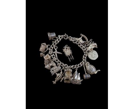 Silver charm bracelet, with sixteen charmsCondition Report:Approx 70 grams