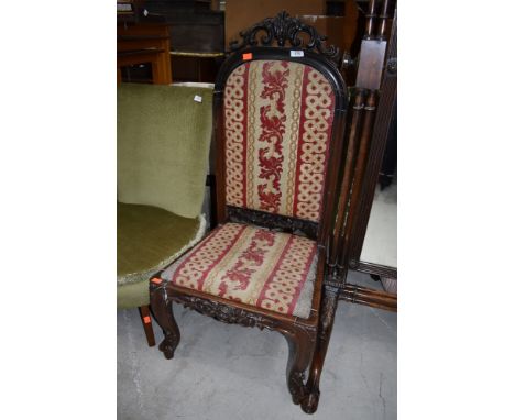 A Victorian low seat hall or nursing chair having tapestry style seat and back