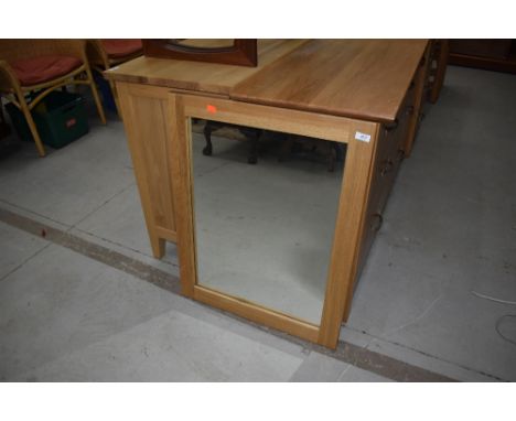 A modern golden oak wall mirror, fixings orientated as portrait, approx 60 x 75cm