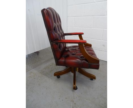 Leather Chair - a Sang de Beouf Leather button back , open arm, swivel office chair with 5 spoke base and casters, brass stud