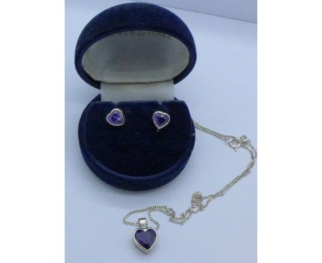 A silver and amethyst pendant and chain with matching earrings