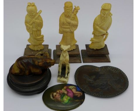 Three carved ivory figures, a carved hardstone netsuke, a Japanese metal pin tray and plaque