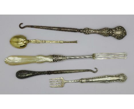 A Victorian silver and mother of pearl pickle fork, a silver handled button hook, etc.