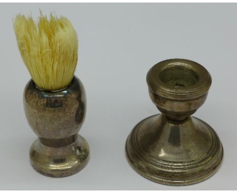 A silver mounted shaving brush and a silver dwarf candlestick