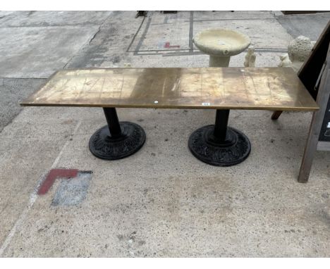 A VINTAGE BRASS COATED BENCH WITH CAST IRON BASES 