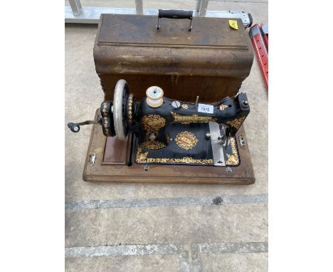 A VINTAGE JONES SEWING MACHINE WITH WOODEN CARRY CASE 