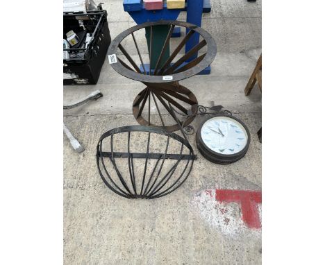 AN OUTDOOR CLOCK, A HAYRACK PLANTER AND A FURTHER METAL TABLE BASE 
