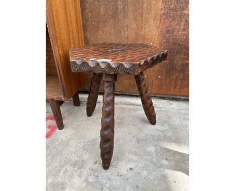 A VINTAGE HARDWOOD THREE LEGGED STOOL 