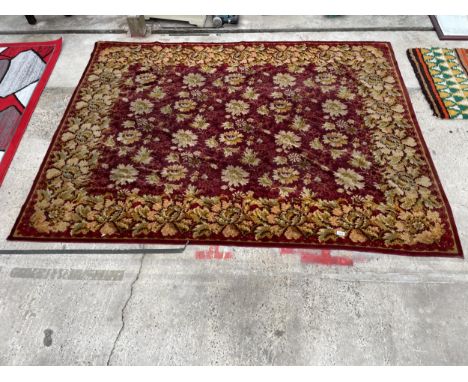 A VINTAGE RED PATTERNED RUG 