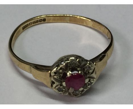 A 9 CARAT GOLD RING WITH CENTRE RUBY SURROUNDED BY DIAMONDS SIZE L/M 