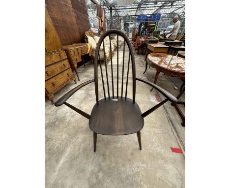 AN ERCOL ELM SPINDLE BACK ARMCHAIR 