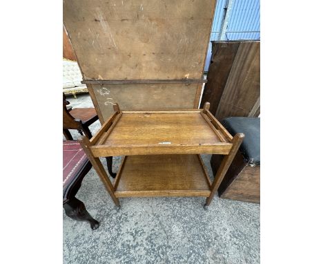 A VINTAGE OAK TWO TIER DRINKS TROLLEY WITH REMOVEABLE TRAY TOP 