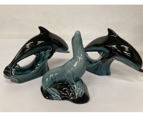 TWO POOLE POTTERY DOLPHIN FIGURES TOGETHER WITH A SEAL 