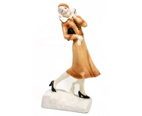 KATZHUTTE; an Art Deco ceramic figure of a girl wearing a cap and flowing brown dress, height 28cm.Condition Report: Minor ch