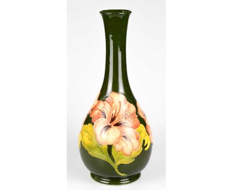 MOORCROFT; a baluster shaped vase decorated in the 'Coral Hibiscus' pattern on a green ground, height 32cm, signed in gilt an