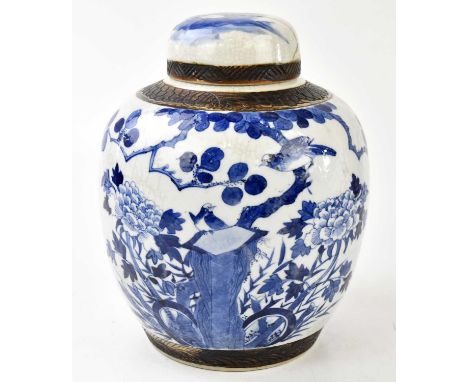 A late 19th century Chinese blue and white porcelain ginger jar and cover, decorated with birds, lotus flowers and floral spr