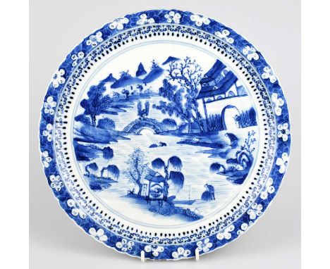 A late 19th/early 20th century Chinese blue and white porcelain plate with a prunus border outside central decoration in a va