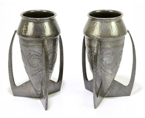 ARCHIBALD KNOX FOR LIBERTY &amp; CO; a pair of Tudric pewter bomb vases with embossed stylised foral decoration on a planishe