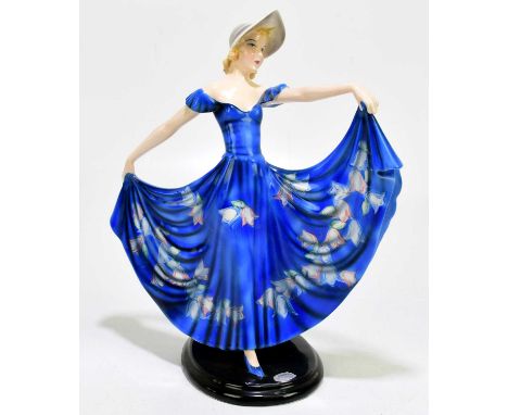 GOLDSCHEIDER; an Art Deco ceramic figure of a female with a bonnet and floral blue oval base with original maker's label, imp