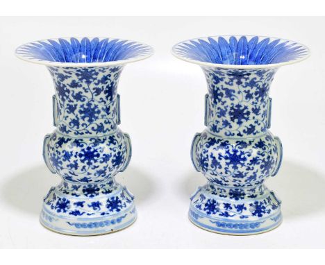 A pair of Chinese porcelain blue and white vases decorated with lotus flowers, with seal mark to the underside, height 21.5cm