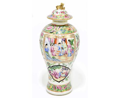 A 19th century Chinese Canton Famille Rose jar and cover decorated with figures inside panels, with floral sprays and exotic 