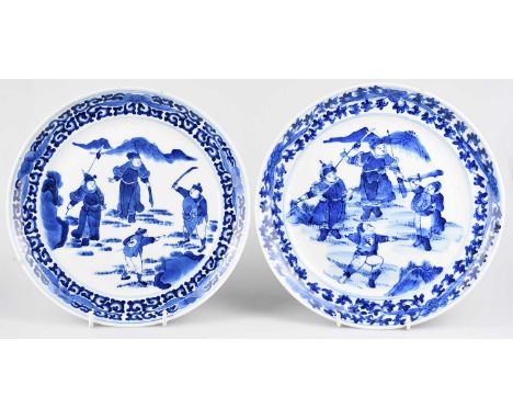 A near pair of 19th century Chinese blue and white Proc plates of circular form decorated with soldiers and figures in landsc