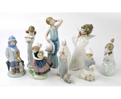 LLADRO; a collection of seven ceramic figures to include a girl holding a basket of flowers, no.5223, a girl with a kitten, n