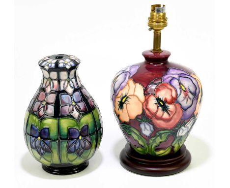 MOORCROFT; a baluster shaped table lamp in the 'Violet' pattern, height 18cm, together with a further table lamp decorated in