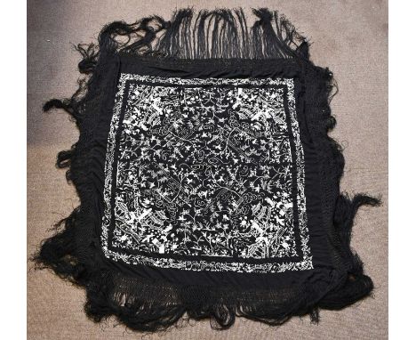 A Chinese white embroidered black silk panel with broad tassel border, main panel approx. 130 x 130xm.