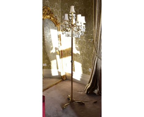 A modern brass five arm standard lamp with crystal drops on three splayed feet, height 185cm.