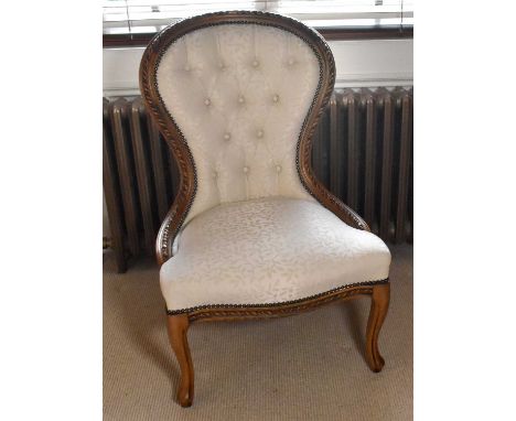 A modern reproduction walnut button balloon back salon chair.