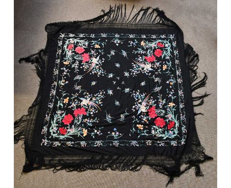 A large Chinese brightly coloured bird and floral embroidered black silk panel with broad frieze, central panel approx. 150 x