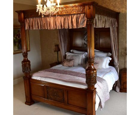 ROYAL OAK FURNITURE COMPANY; a 'Jacobean' four poster bed with carved rose to the headboard and also to the footer, carved ha