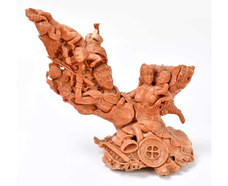 A large and unusual carved coral figure group depicting a warrior, scantily clad female, and four putti beside a large grotes
