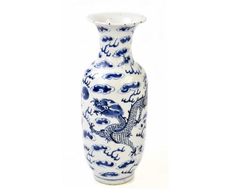 A late 19th century Chinese blue and white porcelain vase with flared neck, decorated with a four claw dragon inside clouds, 