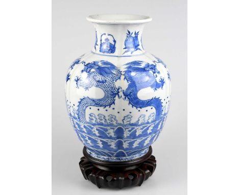 A Chinese blue and white porcelain vase decorated with five claw dragons and stylised fruit and lobsters, on a panelled body,