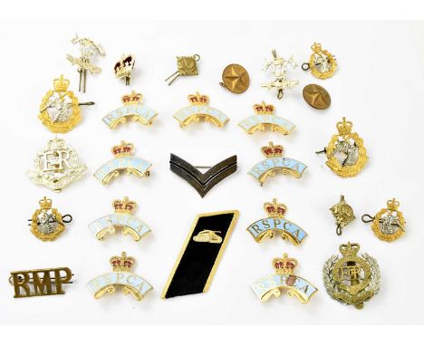 A collection of twenty-six police badges and military badges, including a RMP NCO's badge (26).PROVENANCE: The collection of 