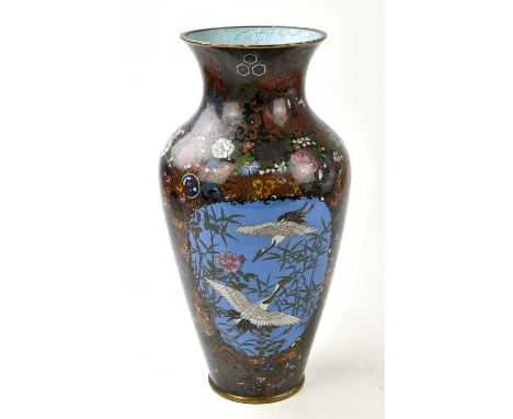 A Japanese cloisonne vase, decorated with three reserves with cranes, birds, and insects, with an all over floral and circula