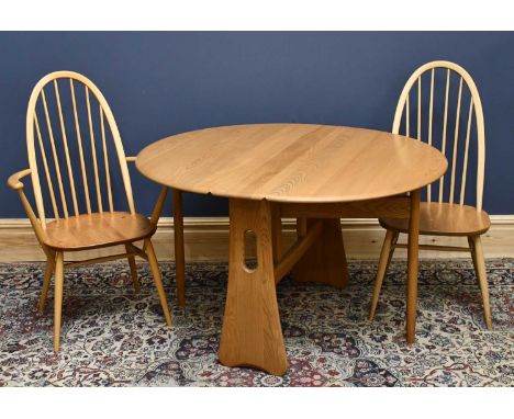 ERCOL; a set of four ash and beech dining chairs, including two arms, with solid seat on turned legs, with an Ercol style dro