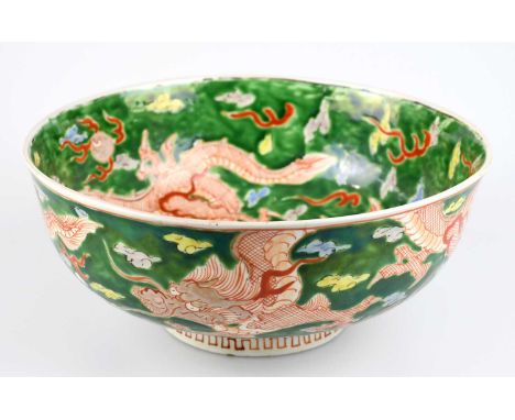 A Chinese Famille Verte footed bowl, decorated with three claw dragon chasing Pearl of Wisdom, with a four character mark to 