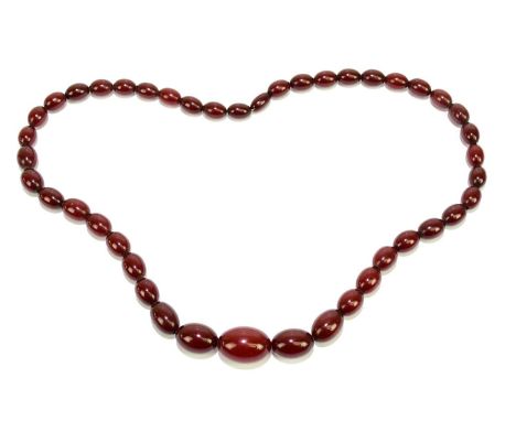 A single strand cherry amber bead necklace, the largest bead 3cm in length, length 37.5cm, weight 87.5g.Condition Report: Non