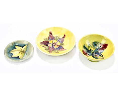 WALTER MOORCROFT; two footed bowls, to include an example decorated in the 'Columbine' pattern, diameter 11cm, together with 
