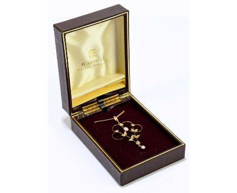 An Edwardian 9ct gold opal and seed pearl set open work pendant, with a yellow metal fine link chain, gross weight of pendant