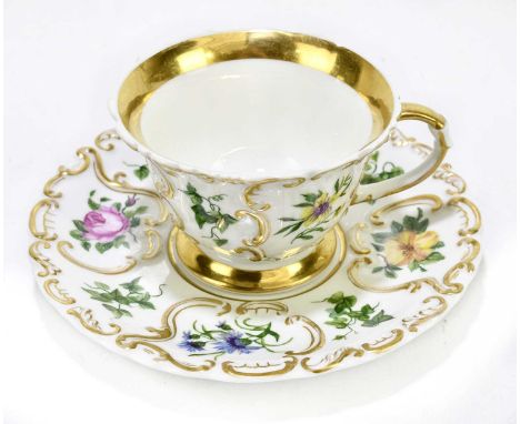 KPM BERLIN; a porcelain tea cup and saucer, with moulded detailing and hand painted with flowers, each with KPM mark and sept