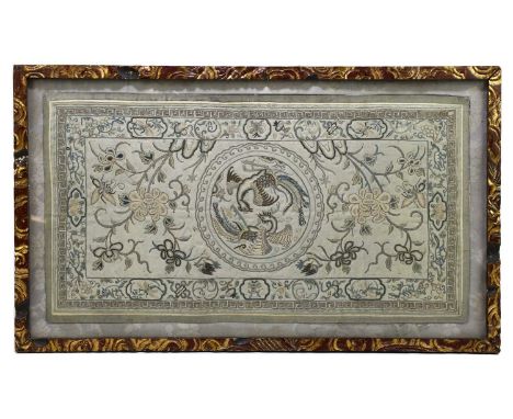 A 19th century Chinese silk work panel, decorated with a central medallion of two phoenix, in a carved and gilt wood frame, p