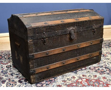 A late 19th/early 20th century vintage metal and wood bound dome top travelling trunk, with faux crocodile detailing and 'BW'