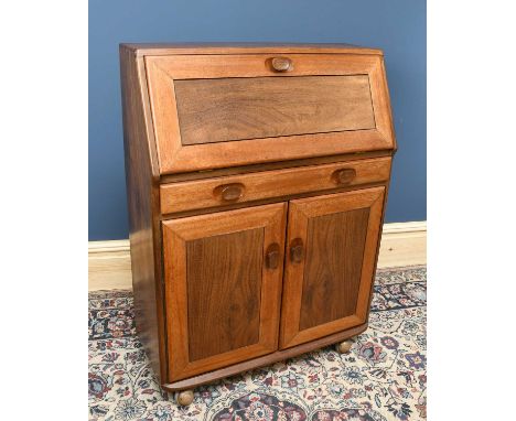 A medium elm bureau, the fall front above single drawer on two panelled cupboard doors, in the manner of Ercol, width 76cm, d